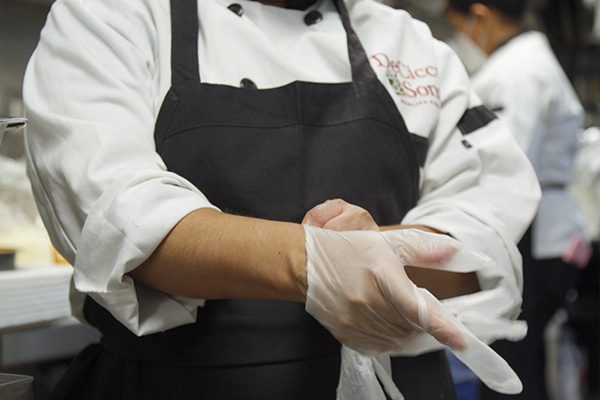 Worker putting on gloves