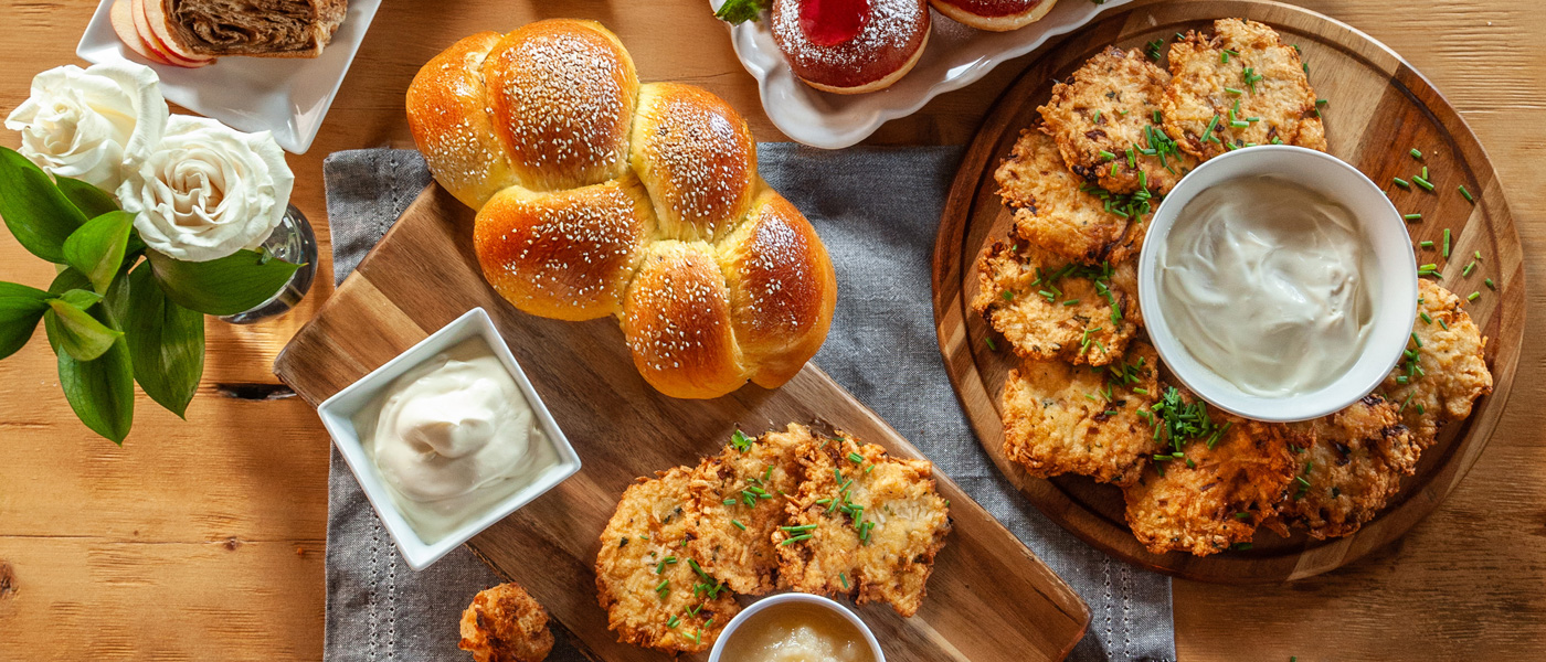 Hanukkah dinner spread with Latkas and Challah bread